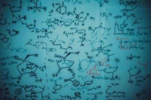 Board with chemical formulas drawn on it