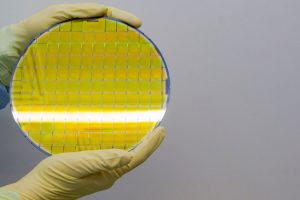 Silicon Wafers Held in Hands